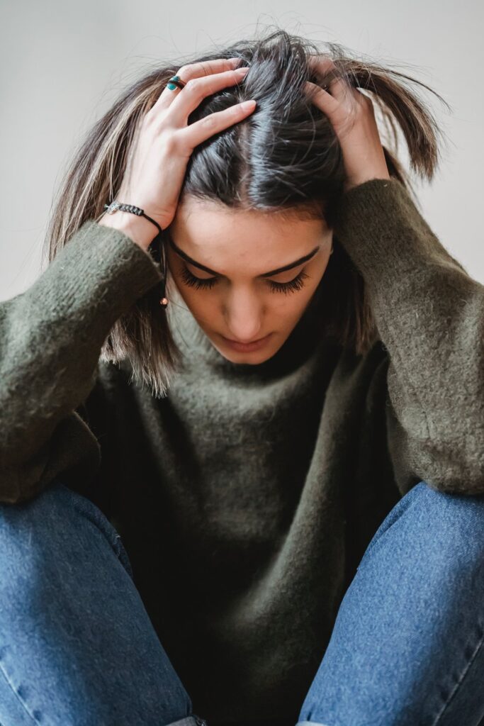 woman facing down the floor