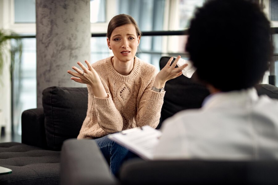 uncertain woman communicating with her psychotherapist doctor