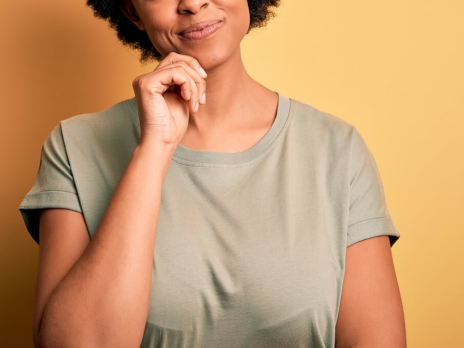 Image of a thoughtful woman touching her chin with her hand. With support from a skilled therapist in South Jersey, you can begin finding self compassion.