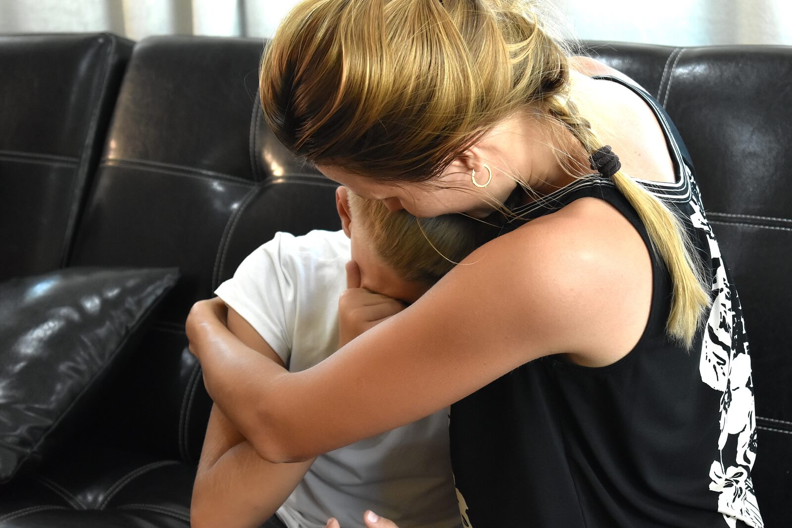 Image of a mother hugging and comforting her crying son. With the support of therapy for children and teens in South Jersey you can help your child begin to cope with their emotions in positive ways.