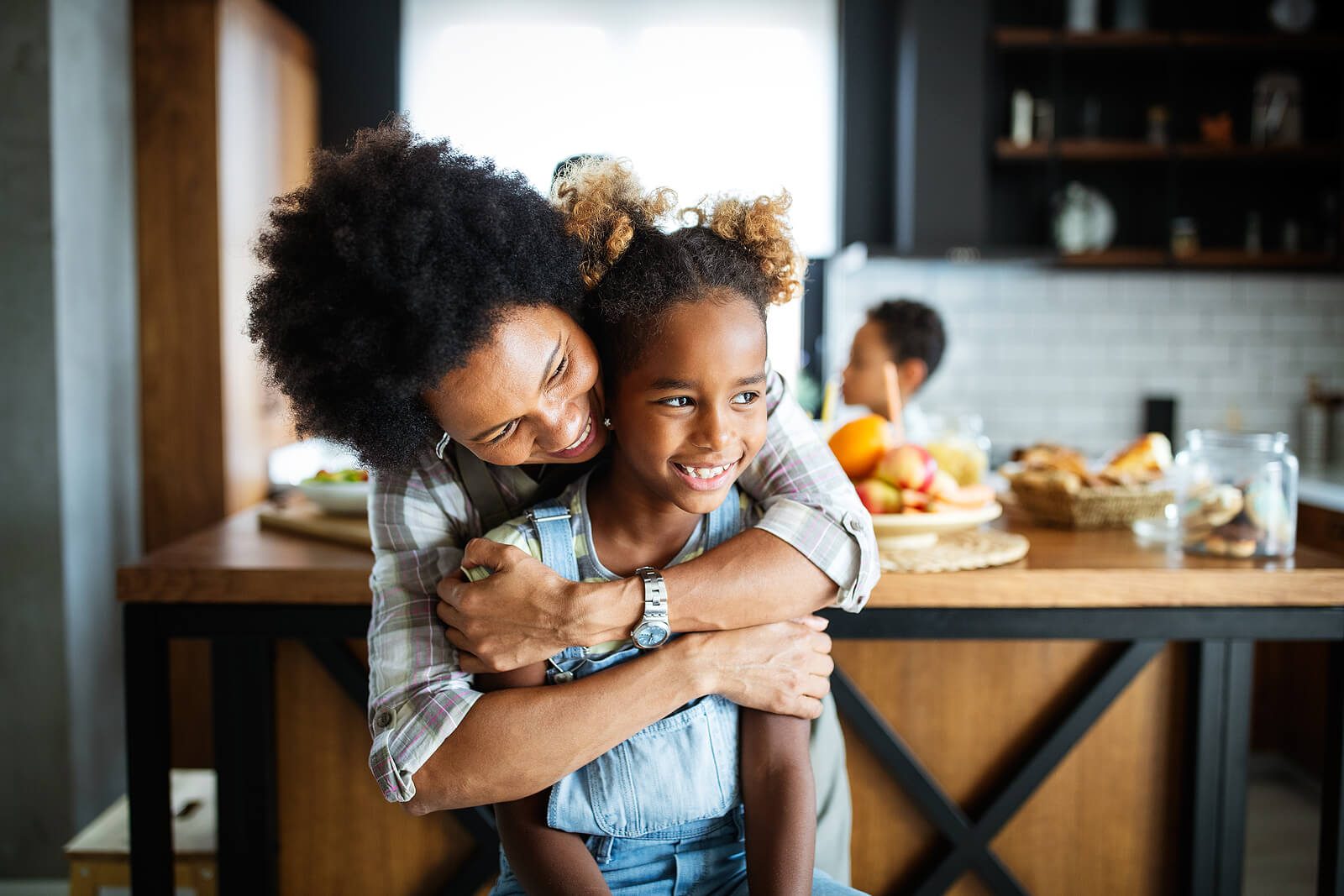 Image of a happy mother and children in the kitchen. Help your child overcome their emotional and behavioral issues with the help of therapy for children in South Jersey. Help them start coping with their struggles in positive ways.