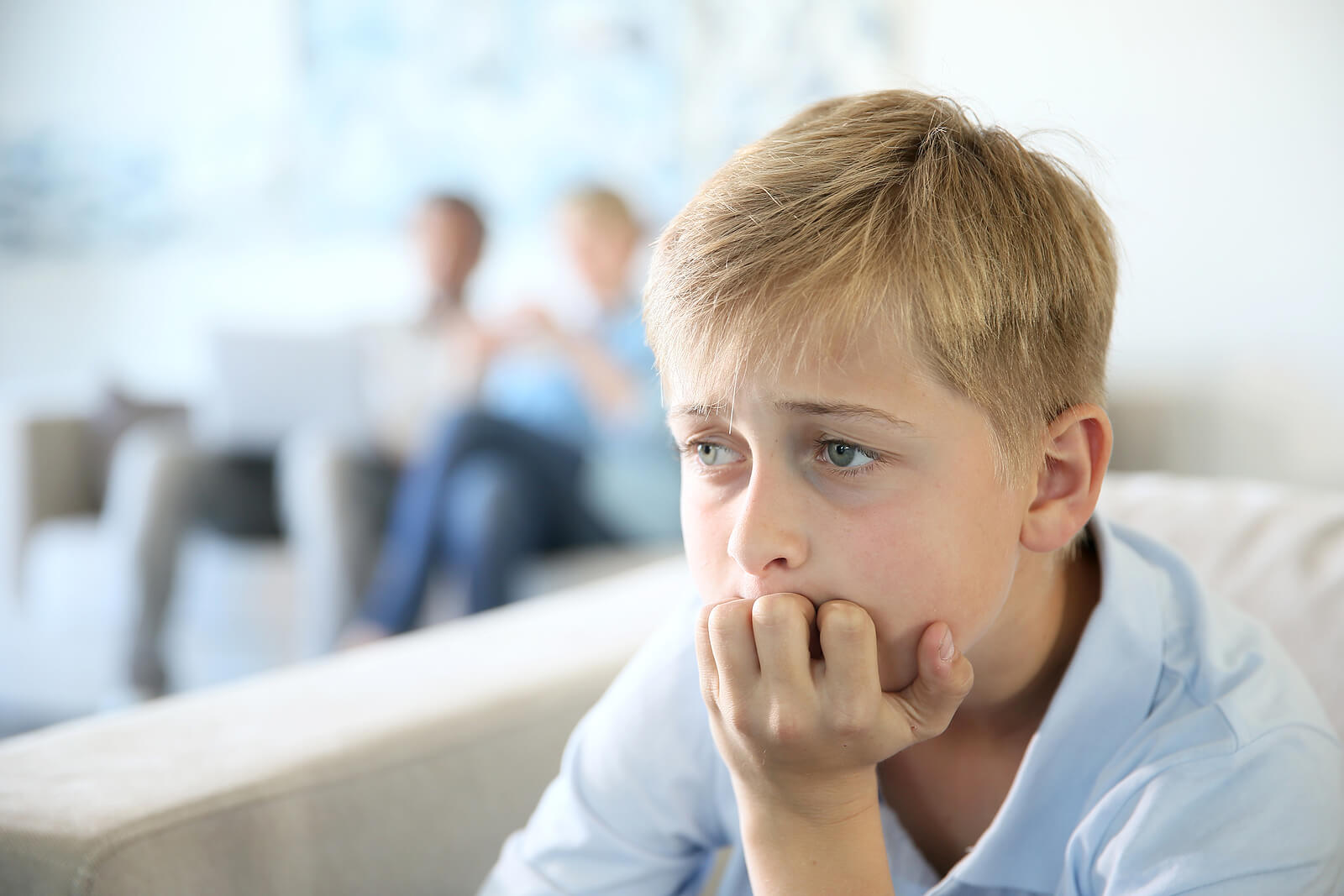 Anxious little boy resting his hand against his mouth. With the help of a supportive child therapist in South Jersey, your child can begin healing from their anxious tendencies in positive ways.