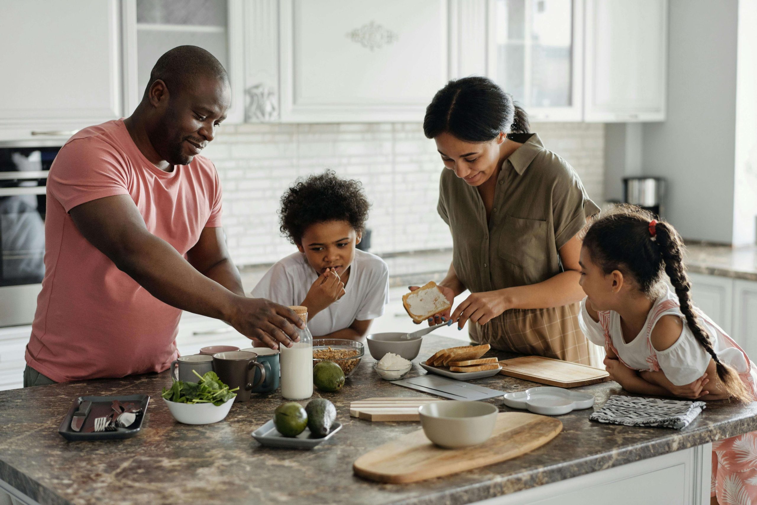 family cooking together | autism testing in south jersey | autism assessment | family support | Marlton | Mt. Laurel | Cherry Hill A smiling family prepares food together in the kitchen. Families can gain clarity and support with autism testing in South Jersey, as autism assessment helps guide children toward the resources they need.