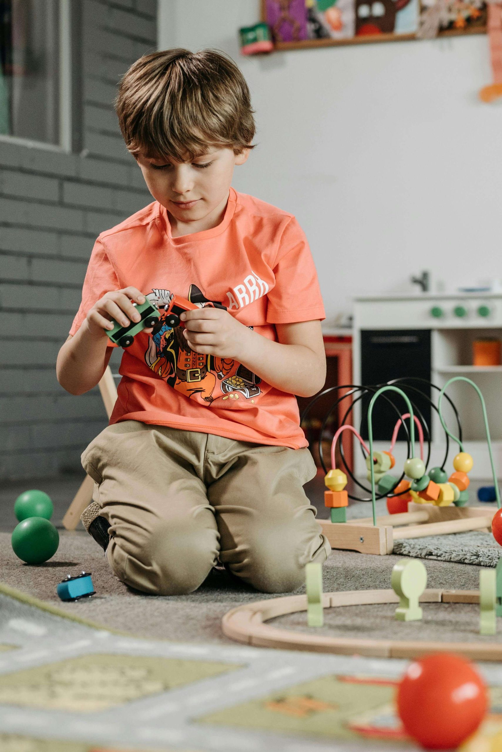 child playing with toy train | autism testing in south jersey | autism assessment | clarity and support | Moorestown | Voorhees | Medford A young boy sits on the floor playing with a toy train during structured play. Begin to find clarity and support through autism testing in South Jersey, where autism assessment can uncover strengths and challenges.