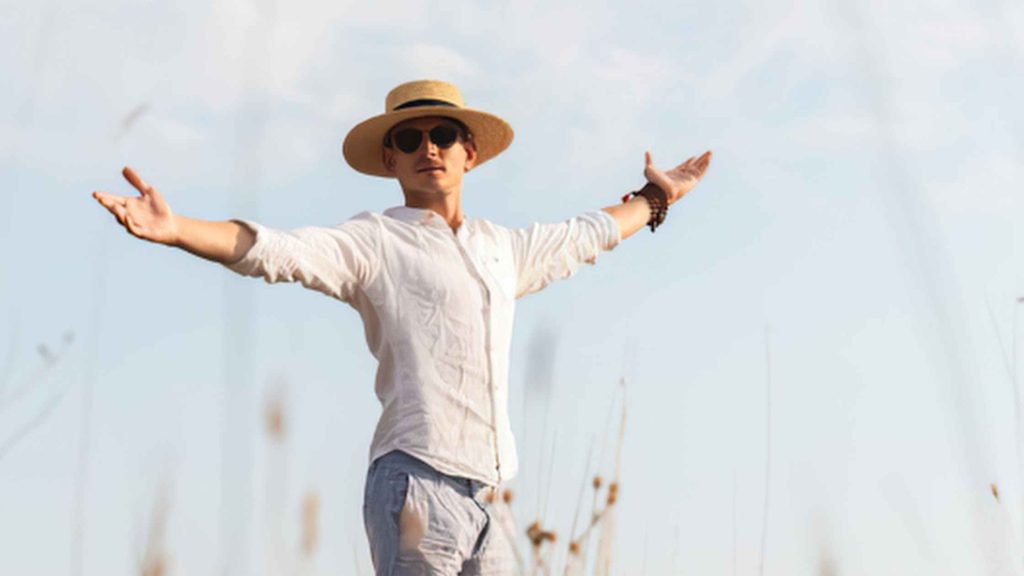 Whole and healing, a mana is looking joyful in a field with his arms outstretched. What Healing from Trauma Can Actually Feel Like A Look at ART Therapy in South Jersey