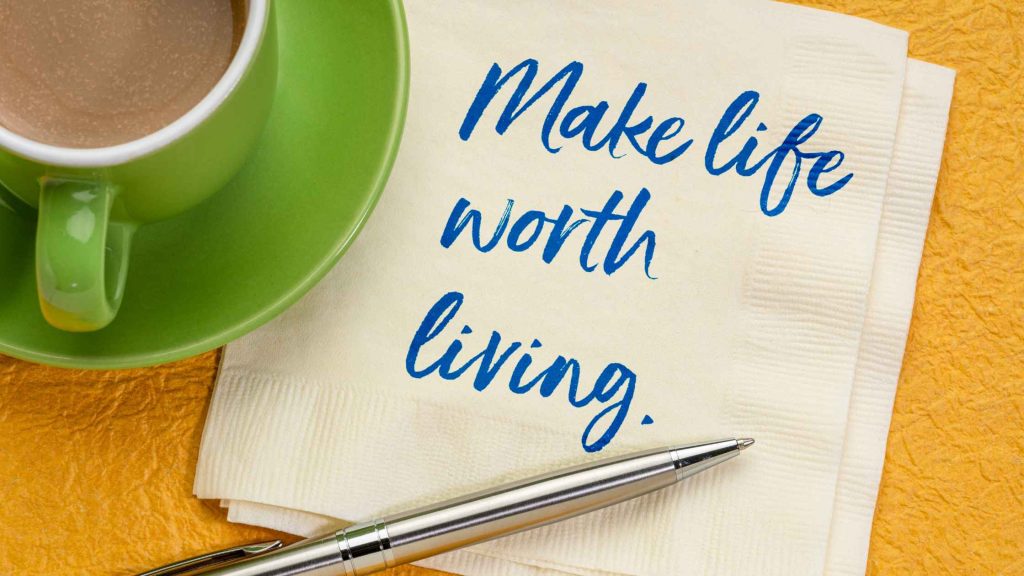 A green coffee mug rests beside a handwritten napkin reading "make life worth living," the DBT philosophy behind Suicide Prevention Month at DBT of South Jersey.